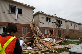 UWO student, Emilio Hong, examining tornado damage in Angus, ON, June 2014.