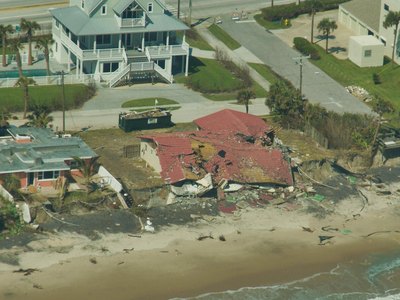 Aerial photograph of coastal erosion undermining a building