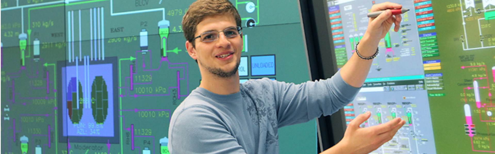 Student in front of display of circuit diagram