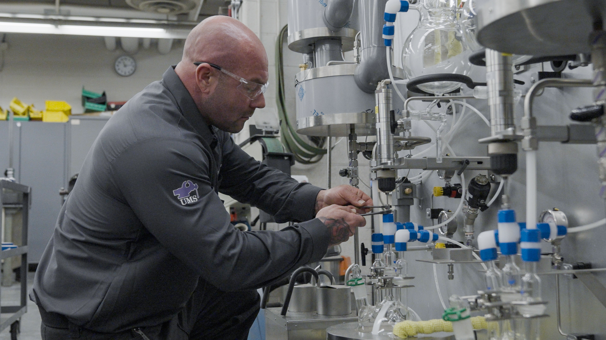 Cody using a wrench to fix a part of the acrylic digester