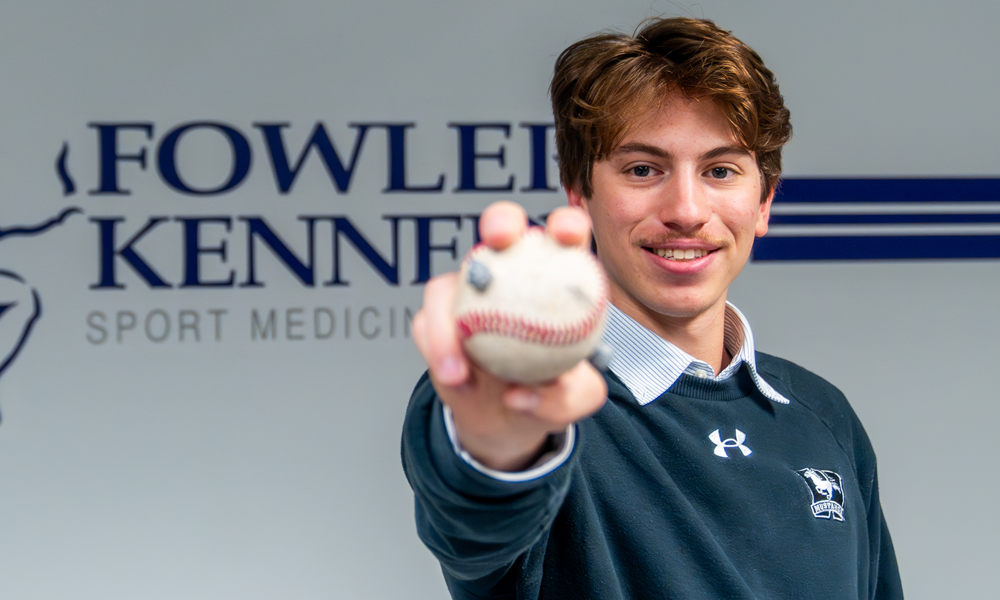 Aaron Austin holding a baseball
